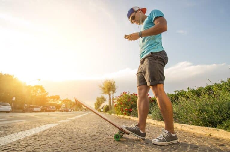Man on longboard at sunset