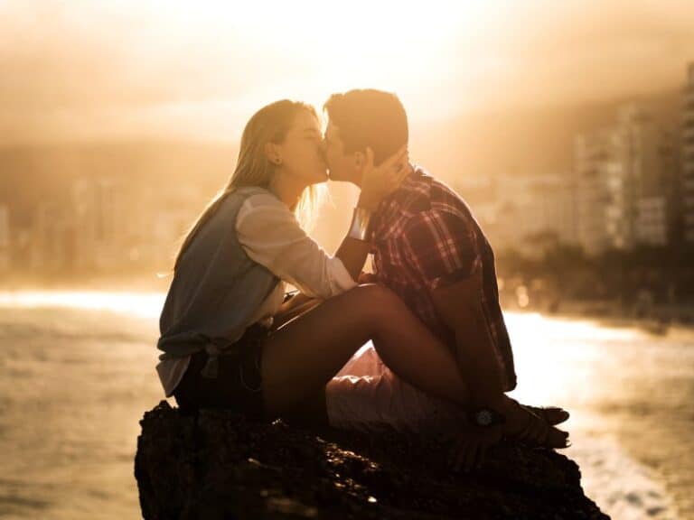 Loving couple sitting on a rock