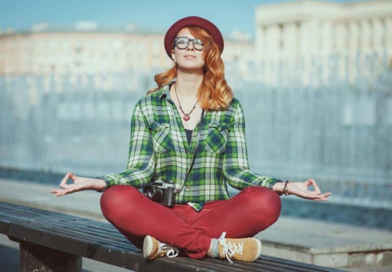 Hipster woman doing yoga at work.
