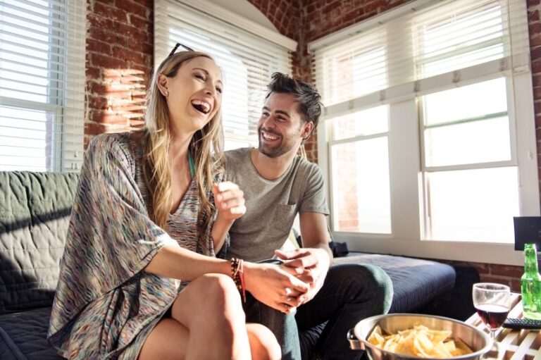 Couple laughing on the sofa
