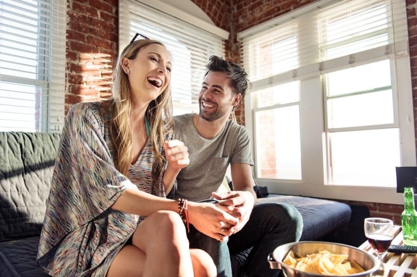 Couple laughing on the sofa