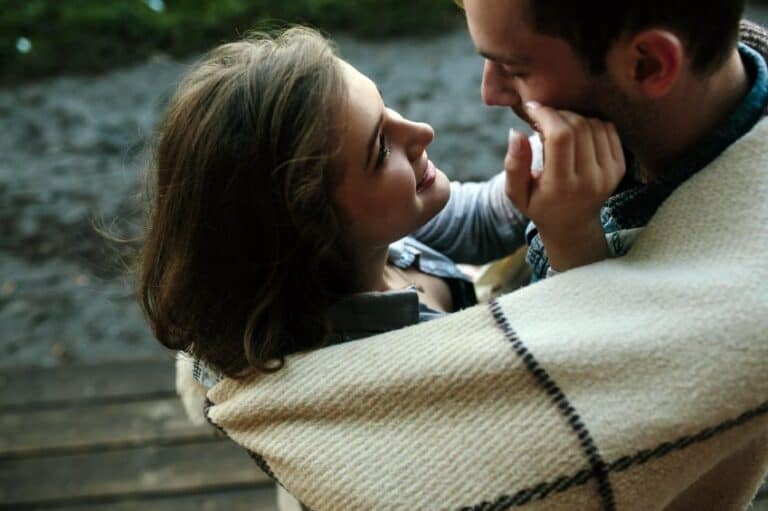 Young couple wrapped in plaid