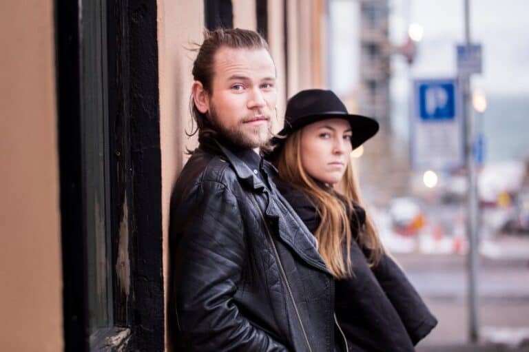 Couple leaning against wall