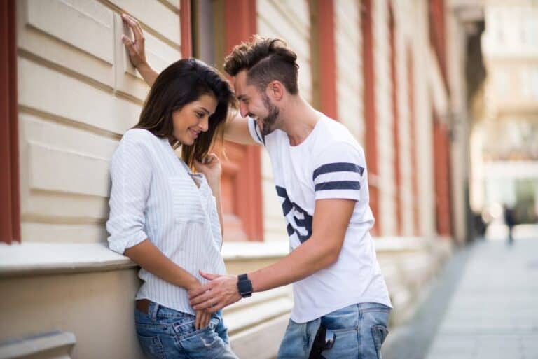 First date couple near wall