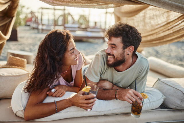 couple having drinks at beach