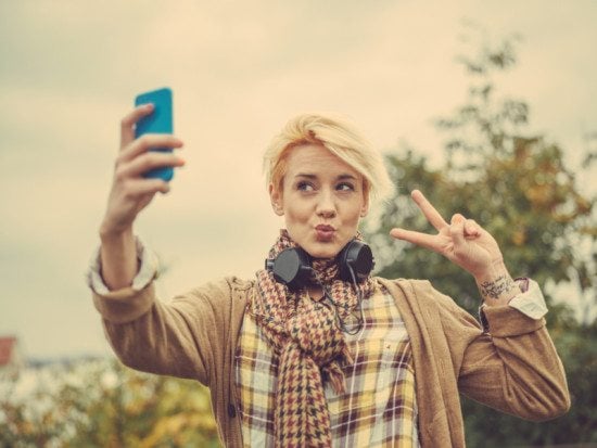 woman taking selfie with peace sign