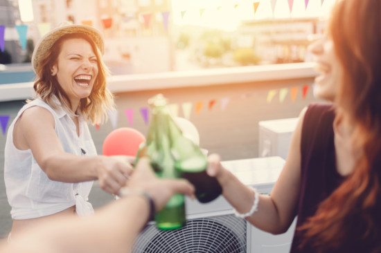 friends toasting at rooftop party
