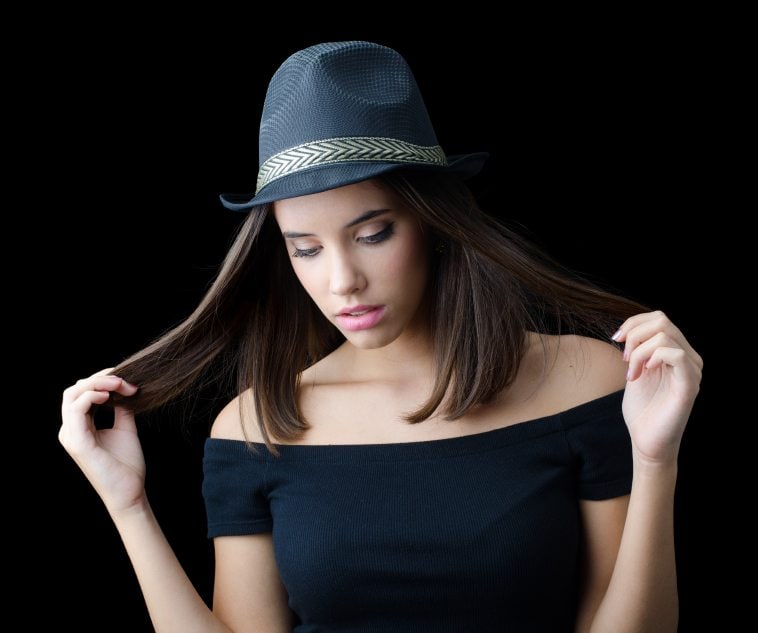 Beautiful brunette girl in black hat