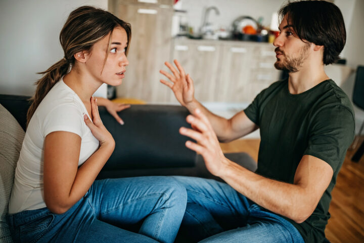 couple arguing on couch