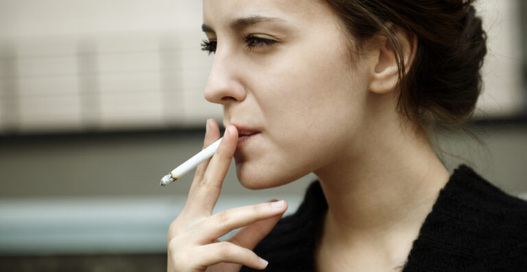 serious woman smoking cigarette