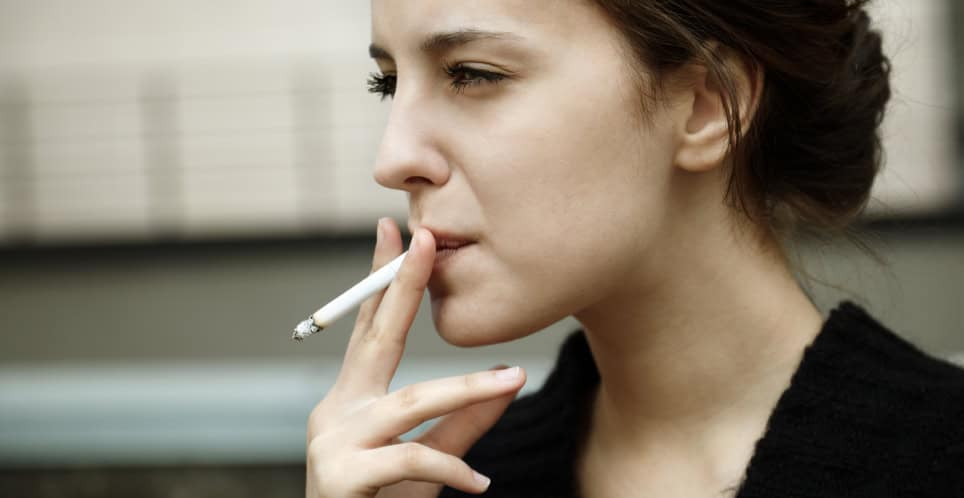 serious woman smoking cigarette