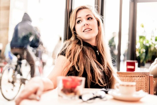 woman looking wistfully in cafe