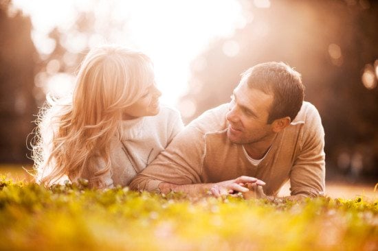 couple having conversation in grass