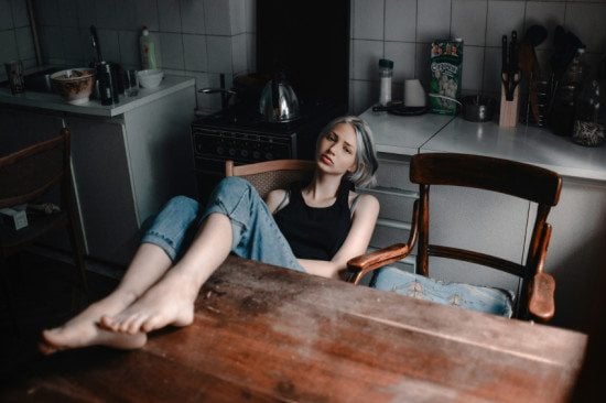sad woman posing in kitchen