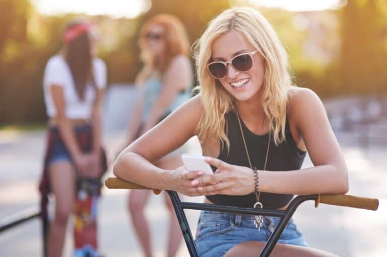 girl texting bike summer sun