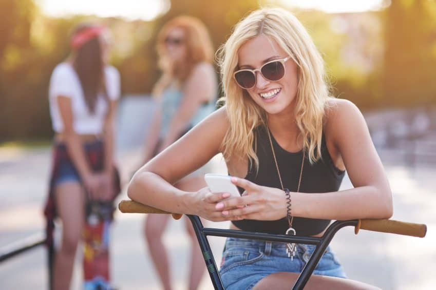 girl texting bike summer sun