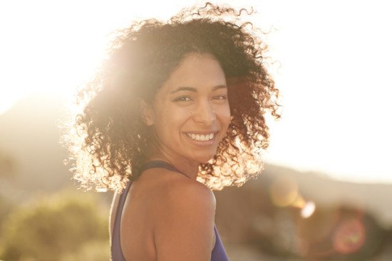 smiling black woman in sunshine