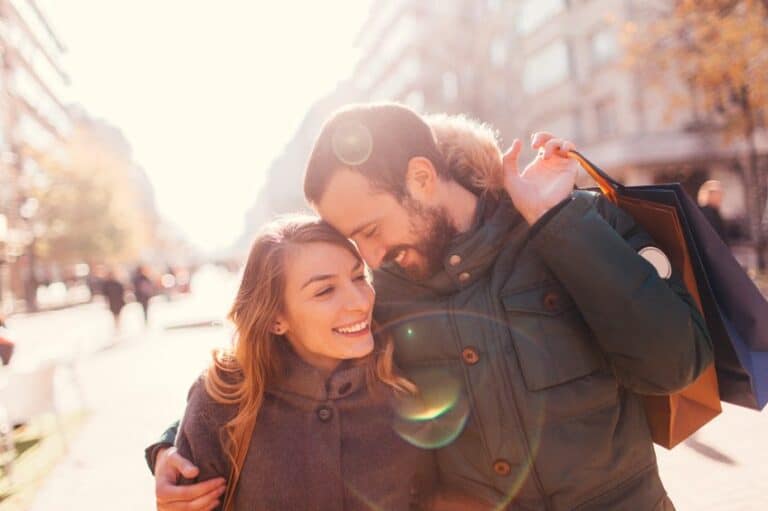 smiling couple walking in winter city