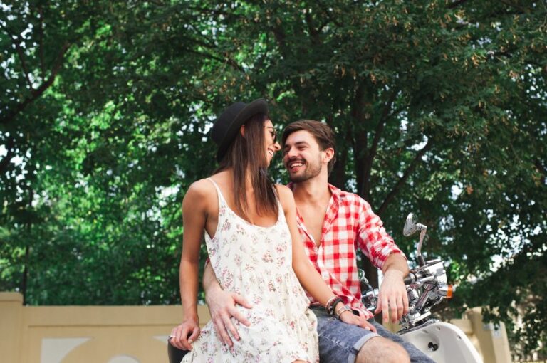 happy couple cuddling in sunny park