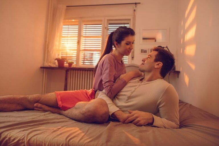 couple waking up in bed in morning