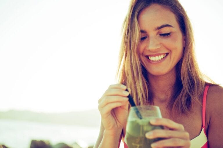 woman happy smoothie beach