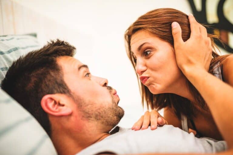 man woman bed funny faces