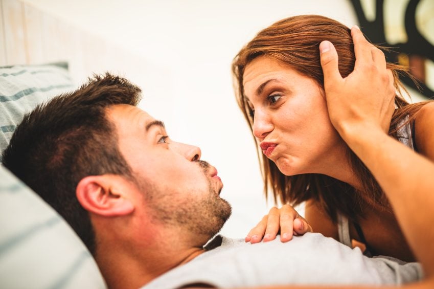 man woman bed funny faces
