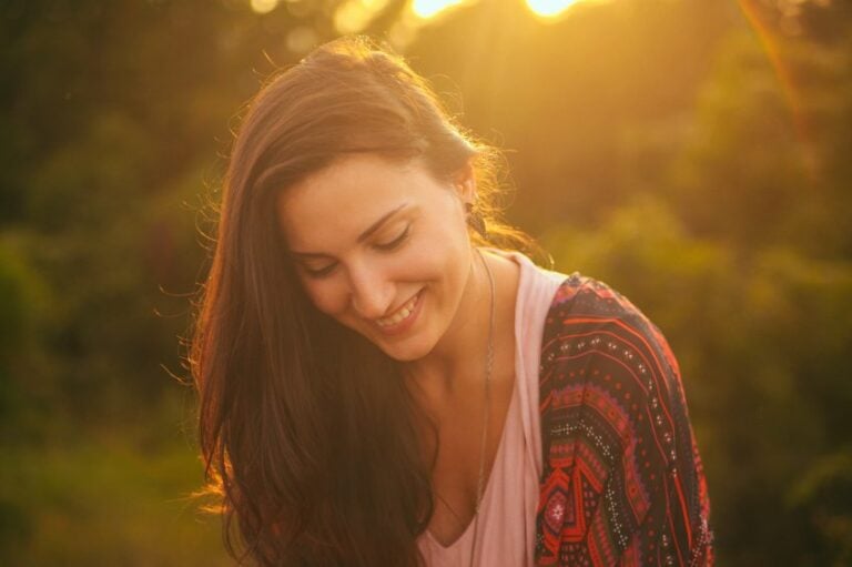 woman smiling outdoors at sunset