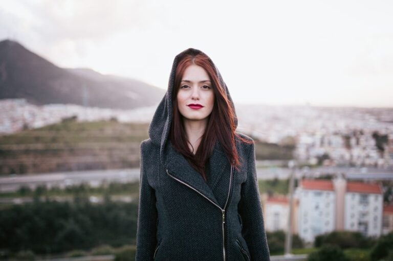 woman on rooftop staring hood up