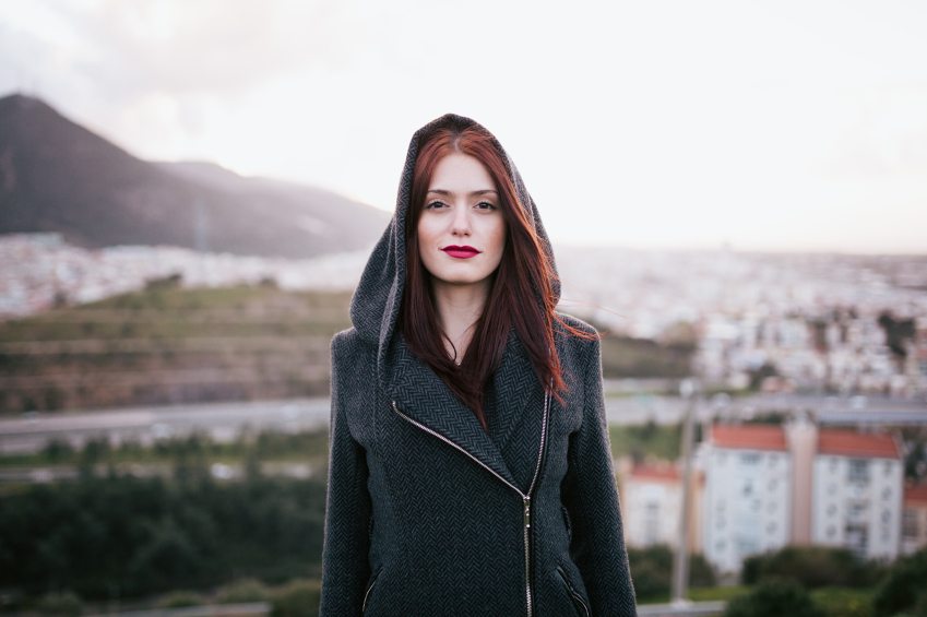 woman on rooftop staring hood up