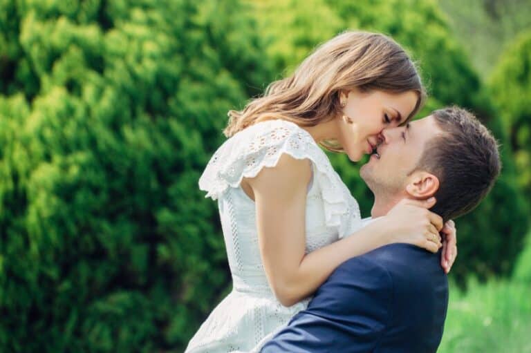couple kissing passionately grass