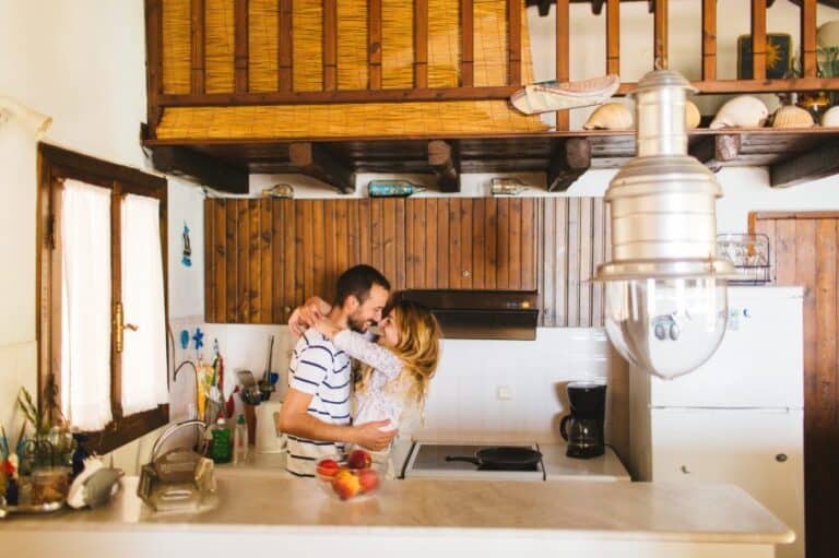 couple kissing kitchen house