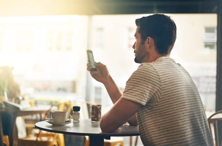 cute guy texting restaurant