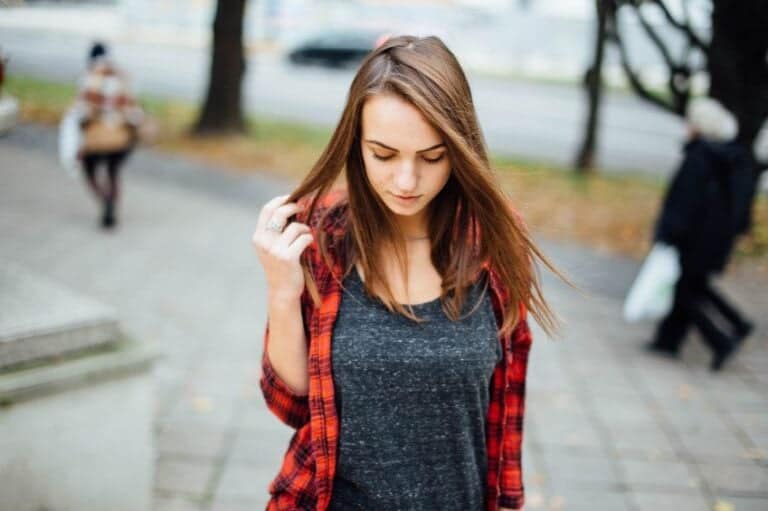 woman looking at the floor sad