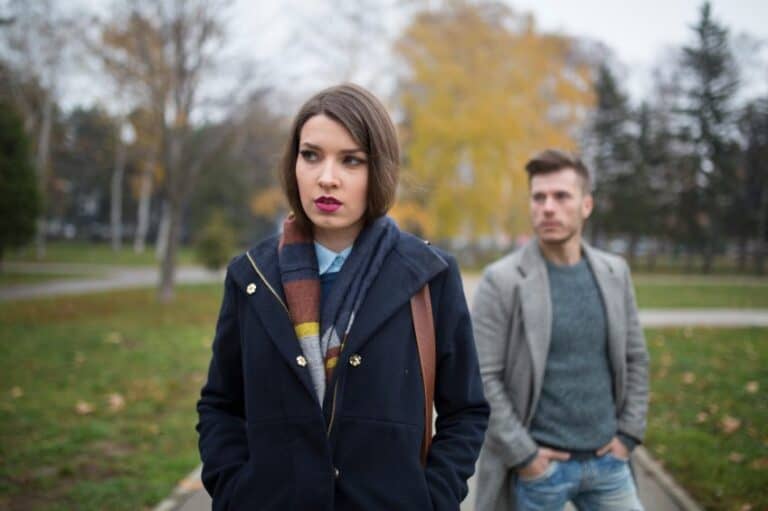 angry woman walking away from boyfriend