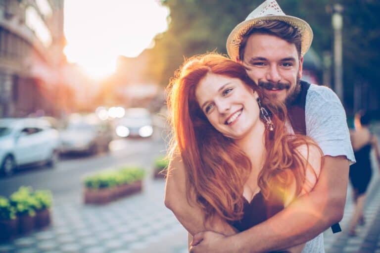 adorable happy couple hugging outside