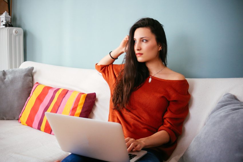 woman couch computer laptop