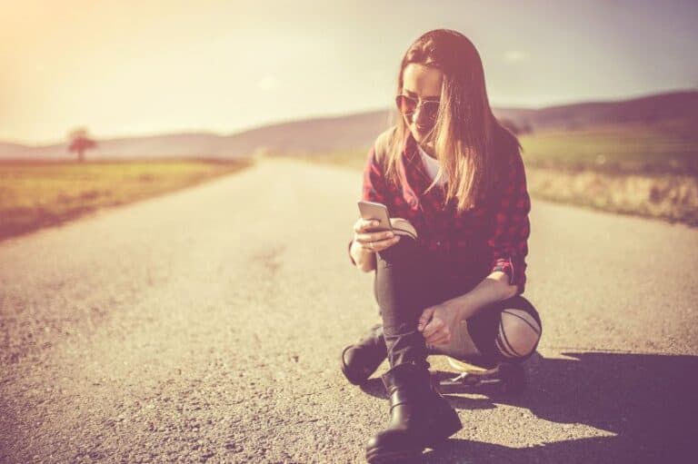 woman sunshine texting phone