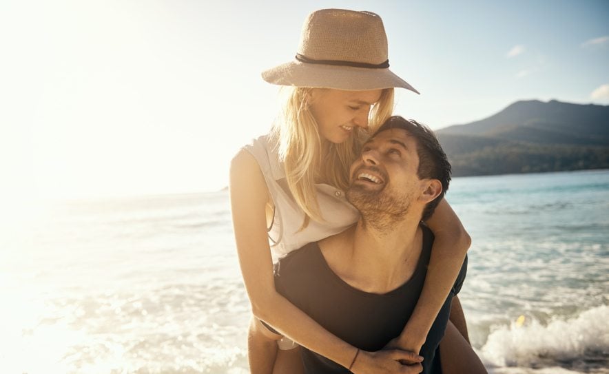 couple close cuddle beach sun