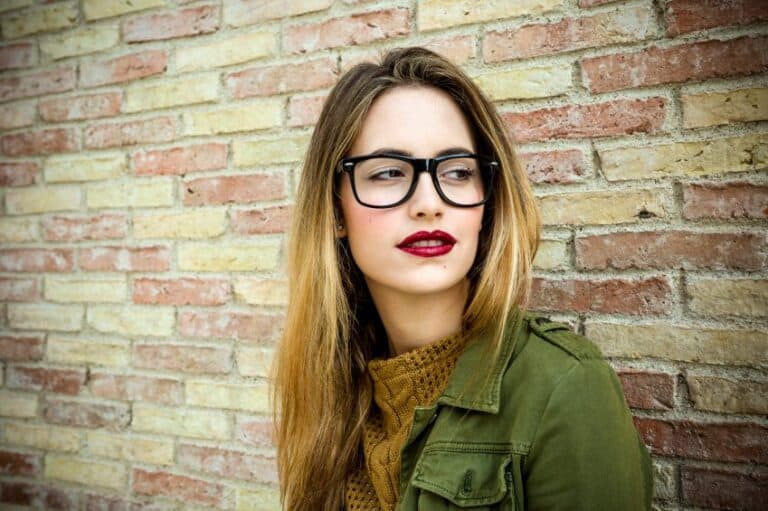 Pensive trendy beautiful girl in glasses