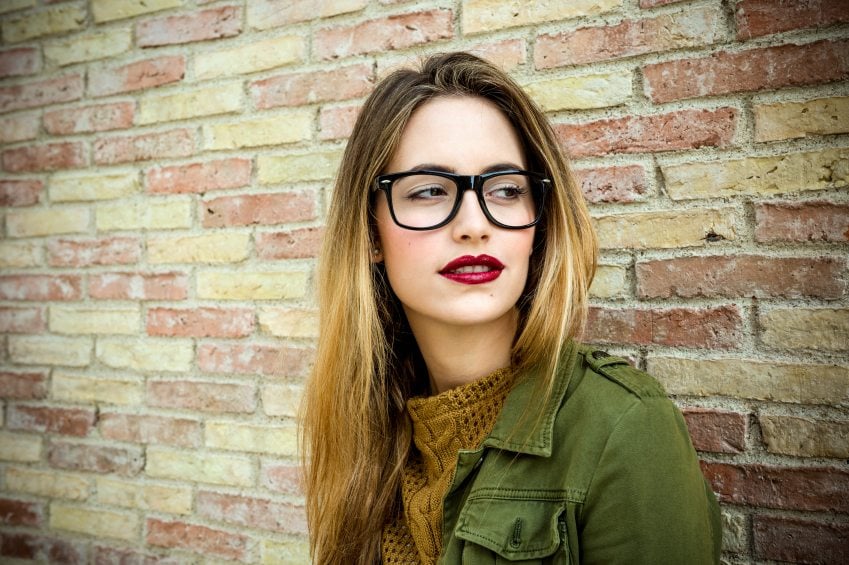 Pensive trendy beautiful girl in glasses