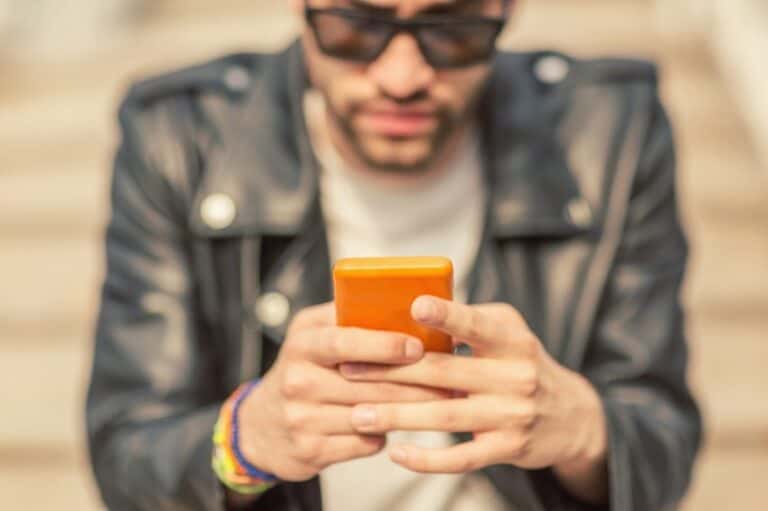 Young hipster with cellpphone