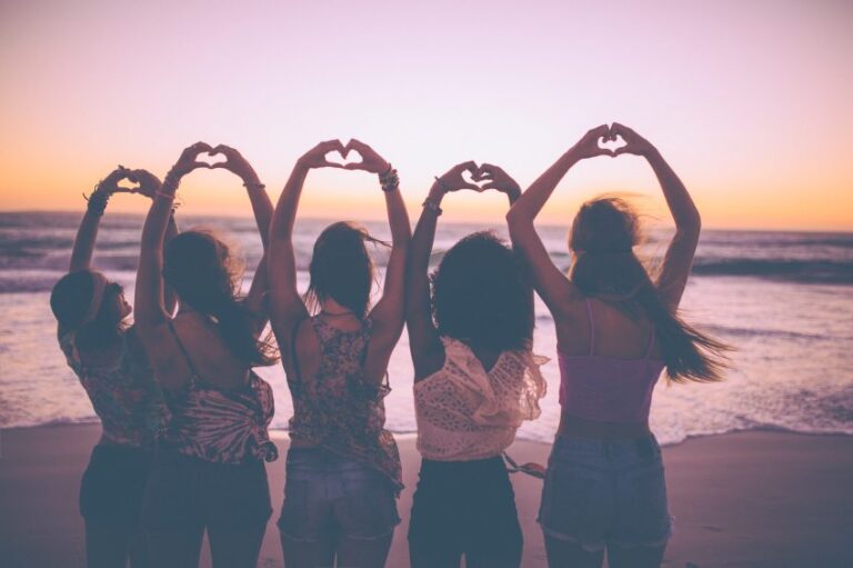 Silhouette of girls making heart shapes