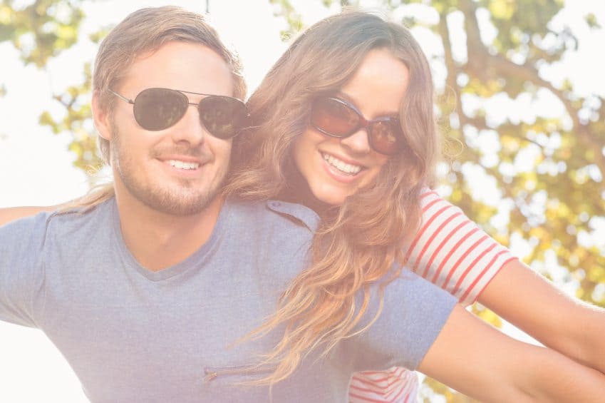 Young couple laughing outside