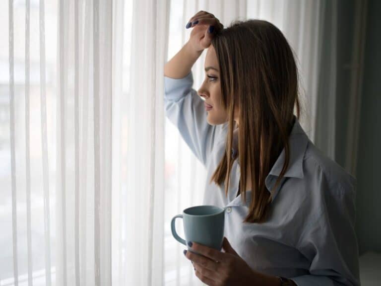 Young pensive woman enjoying in coffee