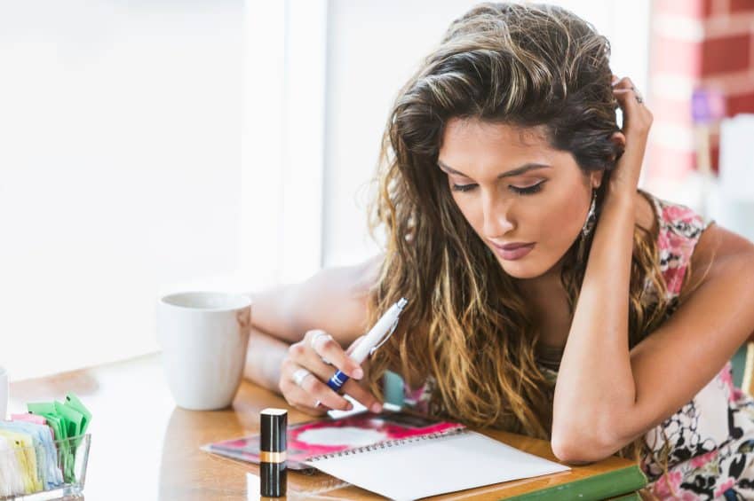 Woman writing in her journal.
