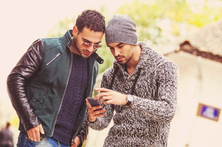 Two male friends looking at mobile