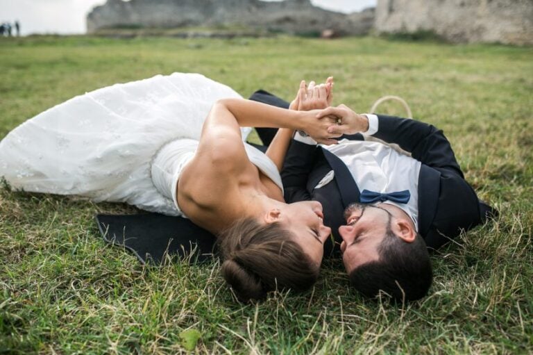 Wedding couple lying on the grass.