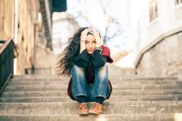 Young woman sat on steps