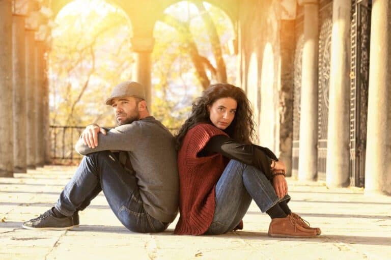 Couple sitting back to back